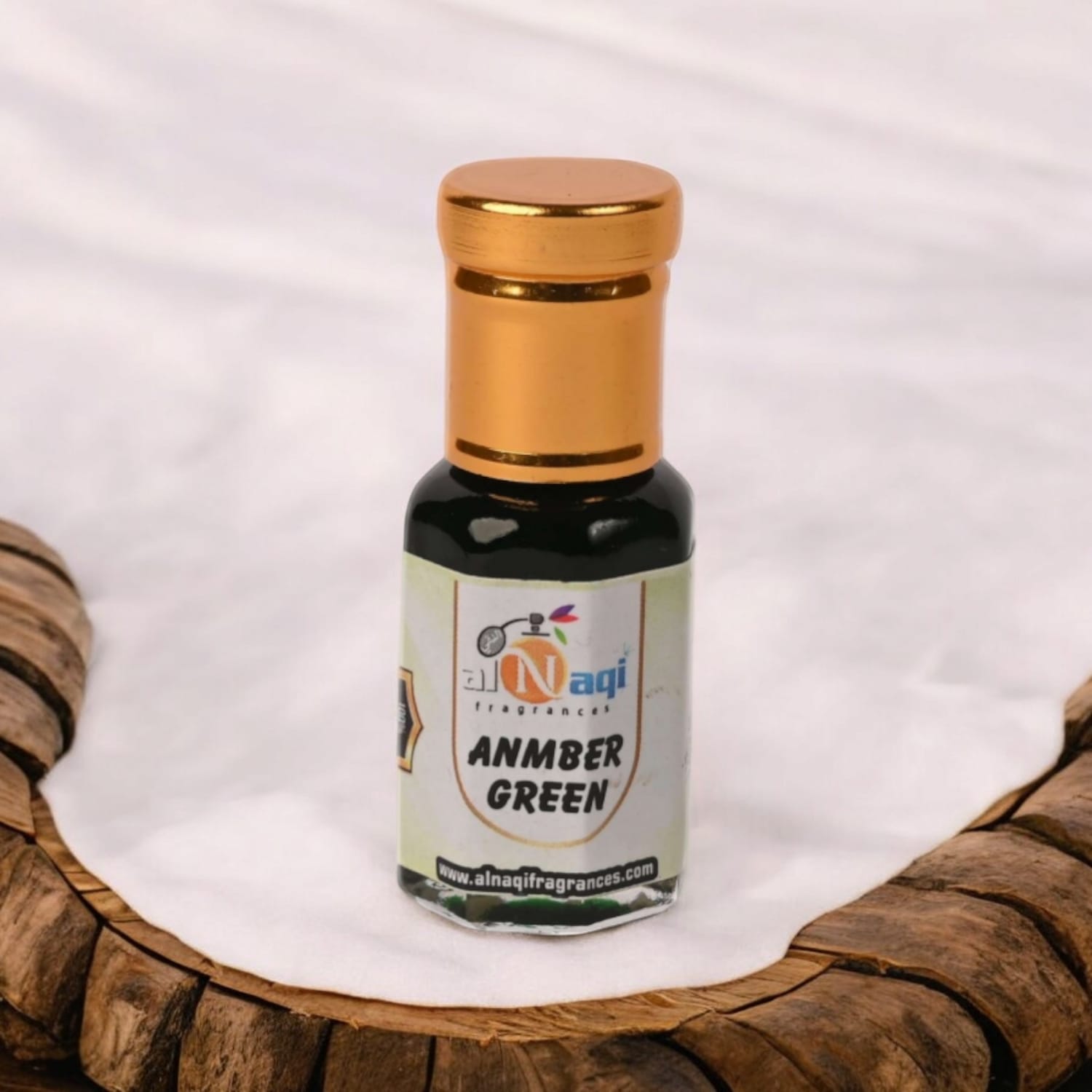 Alnaqi Amber Green Attar in an ambient setting with soft lighting