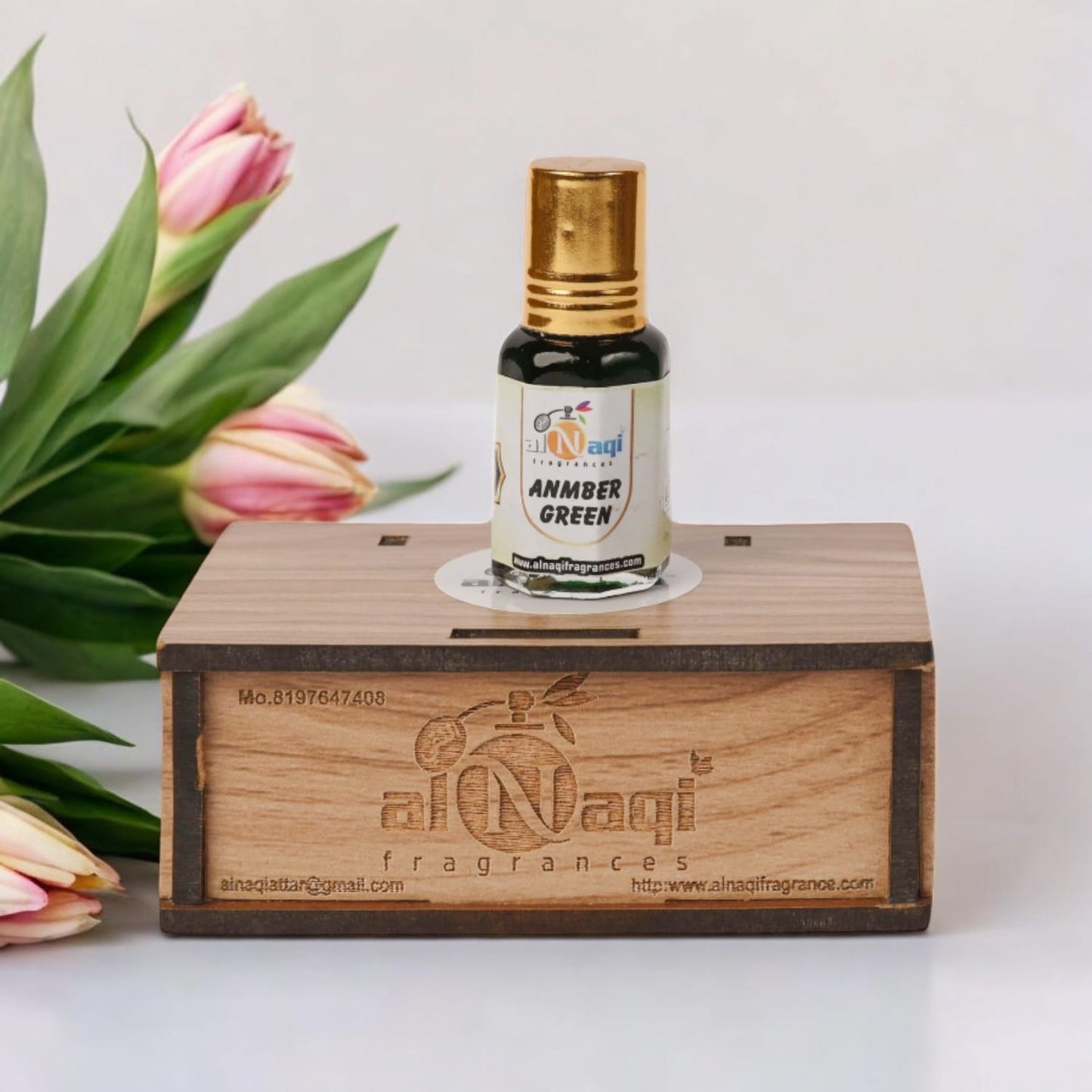 Detailed view of Alnaqi Amber Green Attar with classic glass bottle