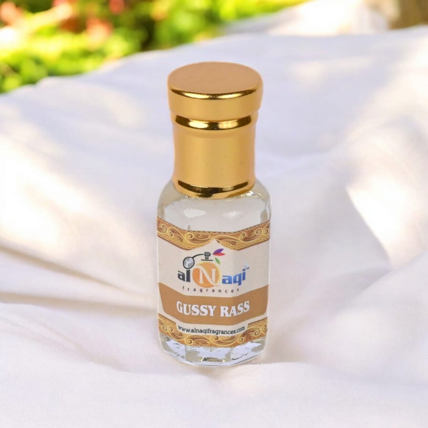 Elegant glass bottle of Alnaqi Madeena Attar with intricate details.