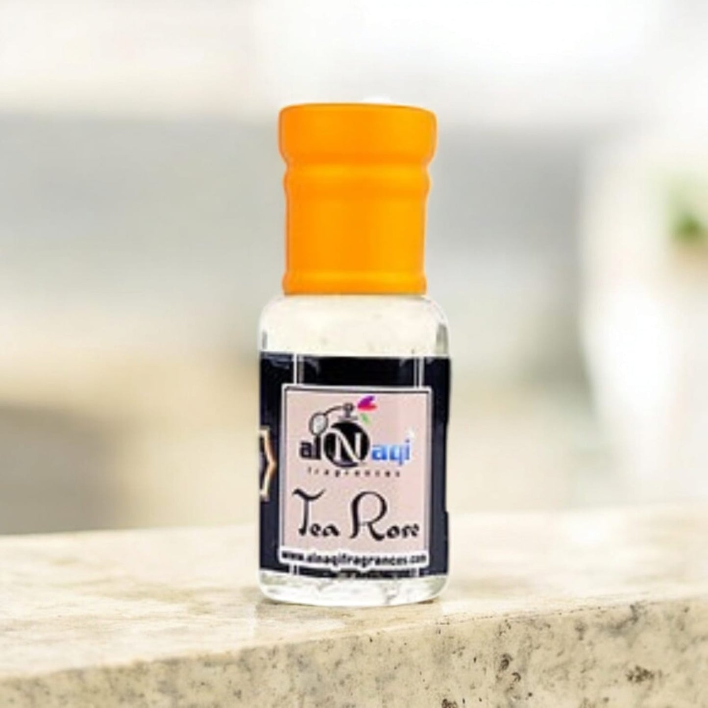 Elegant glass bottle of Alnaqi Tea Rose Essence