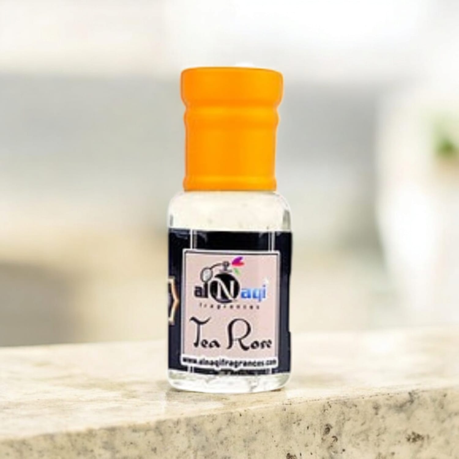 Elegant glass bottle of Alnaqi Tea Rose Essence