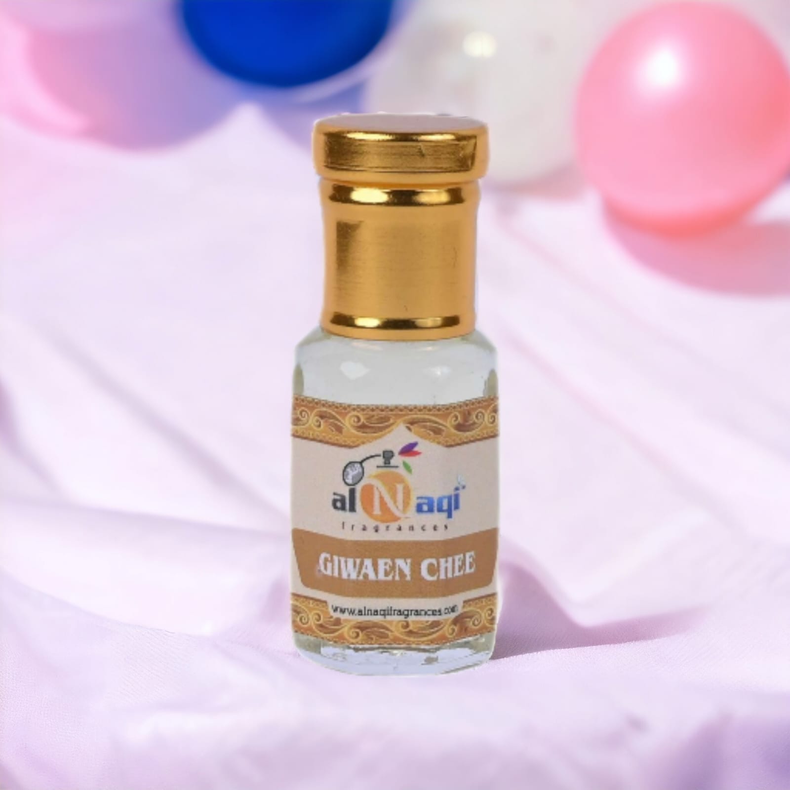 Hand holding a luxurious perfume bottle with floral accents