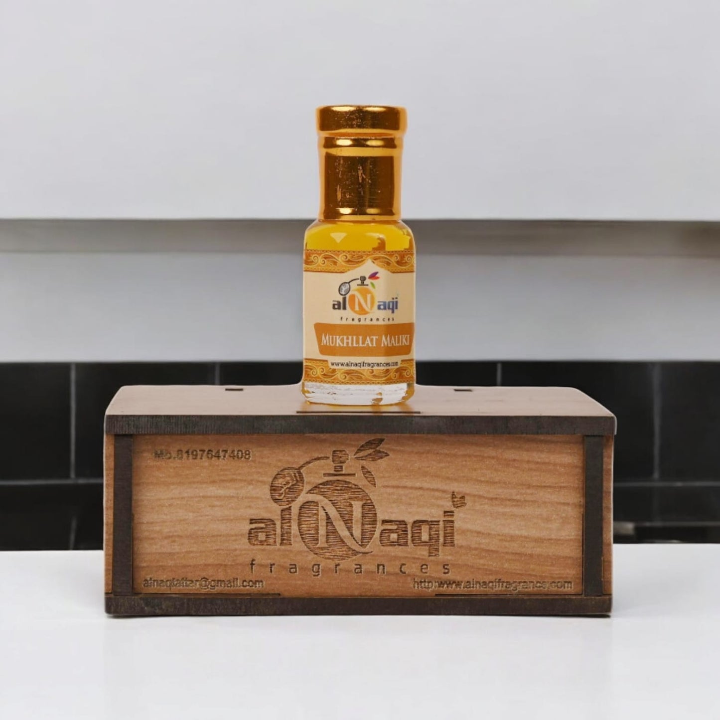 Elegant bottle of Mukhallat Maliki attar on a luxury display