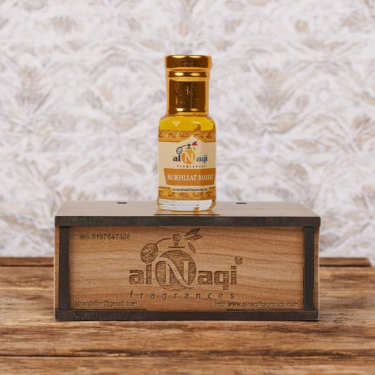 Close-up of Mukhallat Maliki attar showcasing its rich golden hue