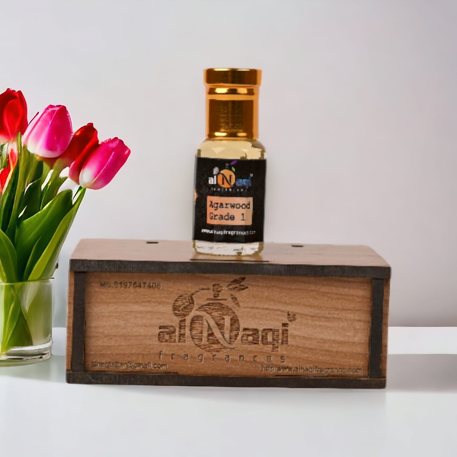Elegant glass bottle of premium attar with a golden cap