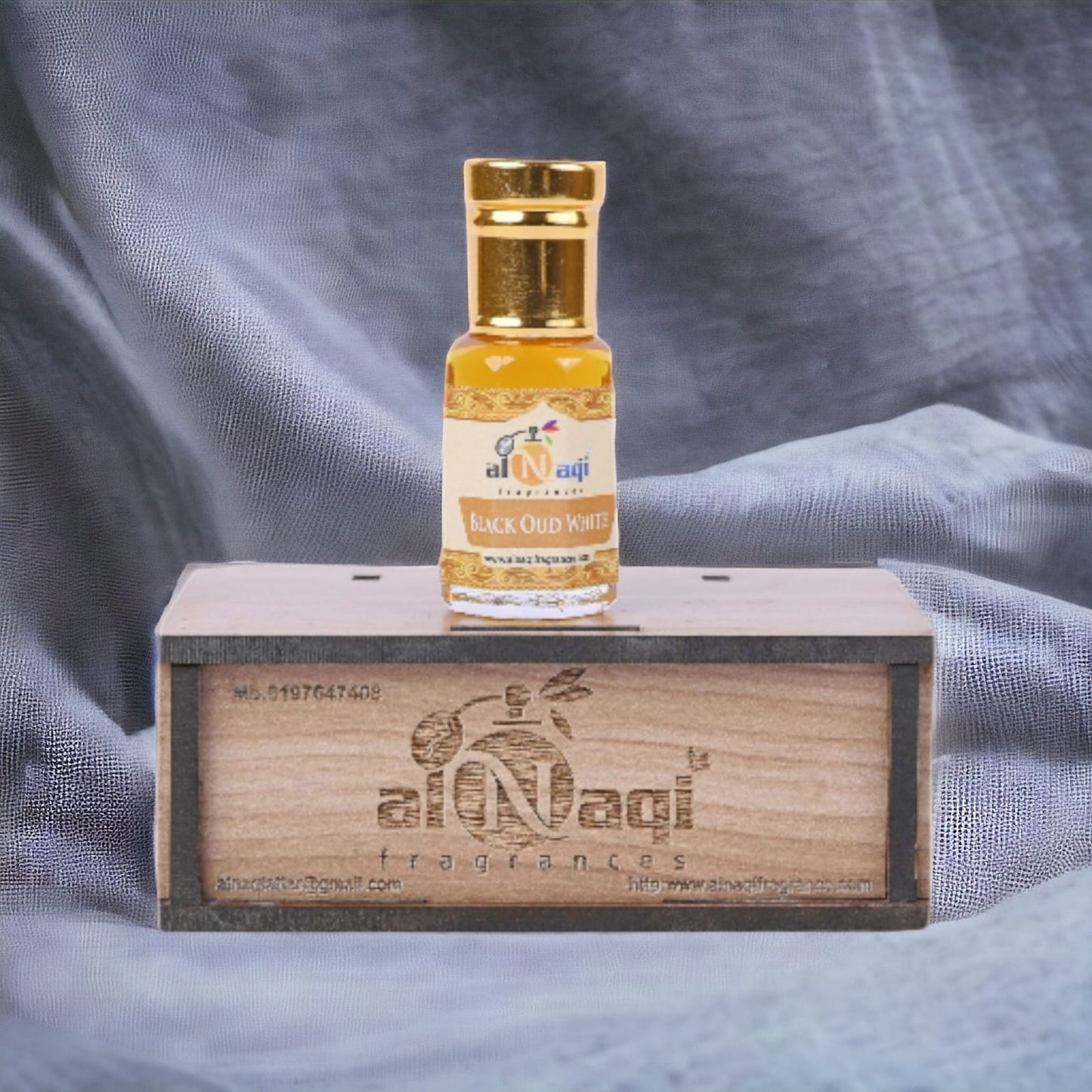 Sleek glass bottle of premium dark perfume with a silver cap