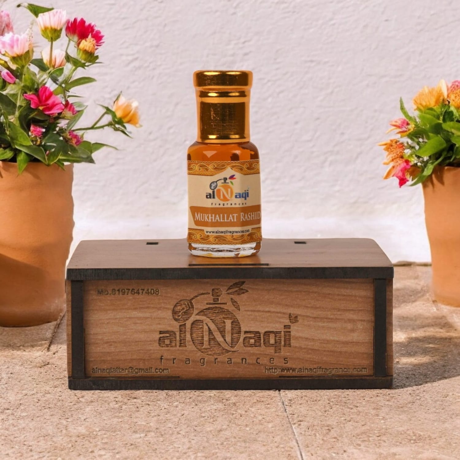 Elegant bottle of Mukhallat Rashid attar with intricate gold detailing.