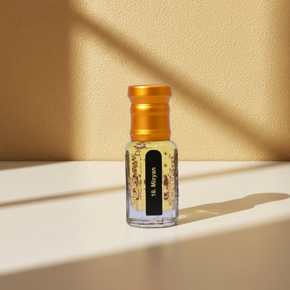 Small glass bottle with a gold cap on a beige background