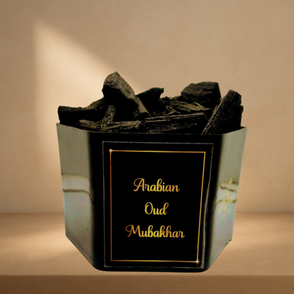 Alnaqi Arabian Oud Mubakhar wood chips releasing aromatic smoke on an incense burner