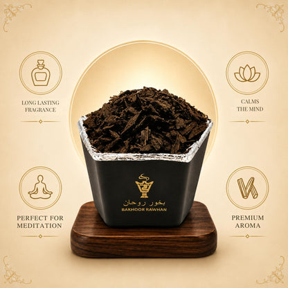 Alnaqi Bakhoor Rawhan wood chips releasing aromatic smoke on an incense burner
