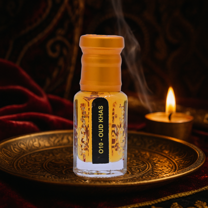 Small bottle labeled 'Oud Khas' on a decorative tray with a candle in the background