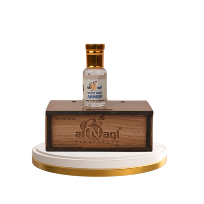 Small bottle with gold cap on a wooden stand with 'al Naqi' branding.