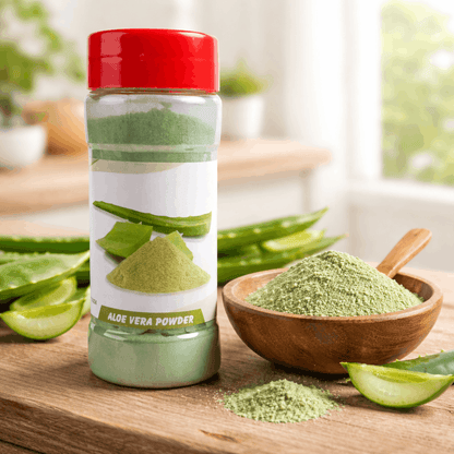 Bottle of aloe vera powder with a red lid on a wooden surface with a bowl of powder and aloe vera leaves.