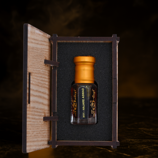 Small bottle with a gold cap in a wooden box on a dark background