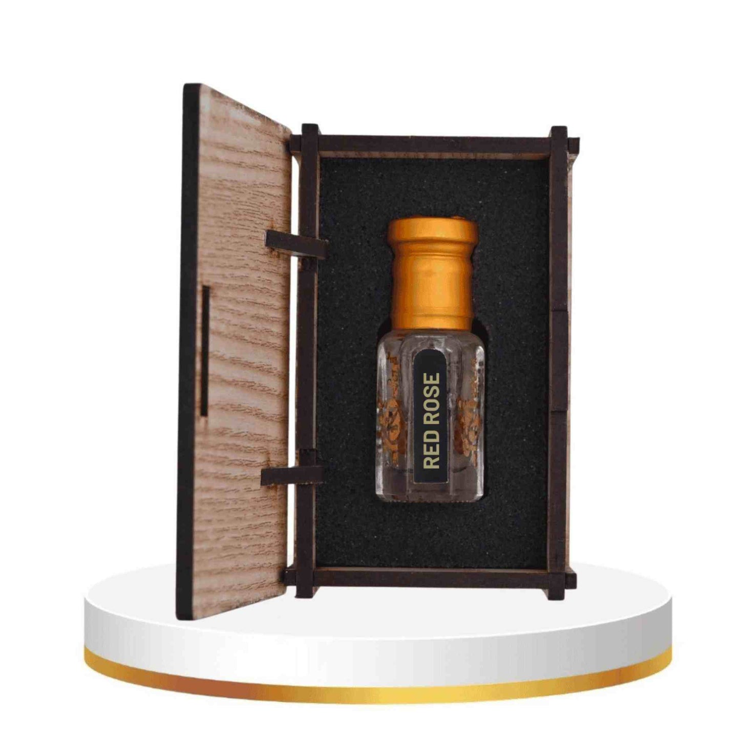 Perfume bottle labeled 'Red Rose' in an open wooden box on a white platform.