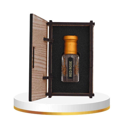 Perfume bottle labeled 'Red Rose' in an open wooden box on a white platform.