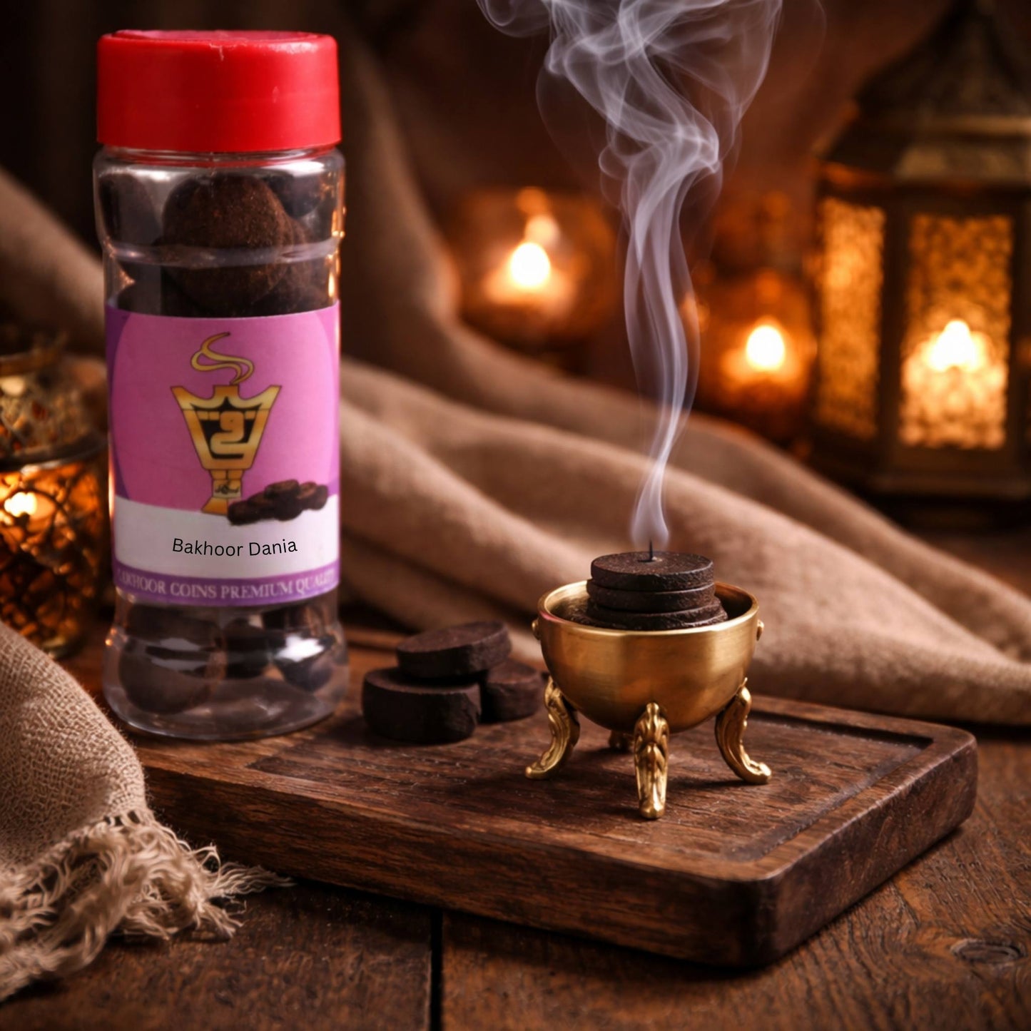 Bakhoor Dania incense bottle with smoking incense burner on a wooden surface.
