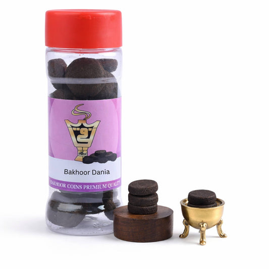 Bottle of Bakhoor Dania with a red cap and purple label on a white background