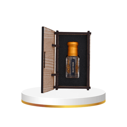 Al-Naqi fragrances bottle with wooden box and flowers in the background