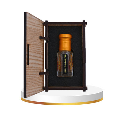 Bottle with wooden cap inside an open wooden box on a white background