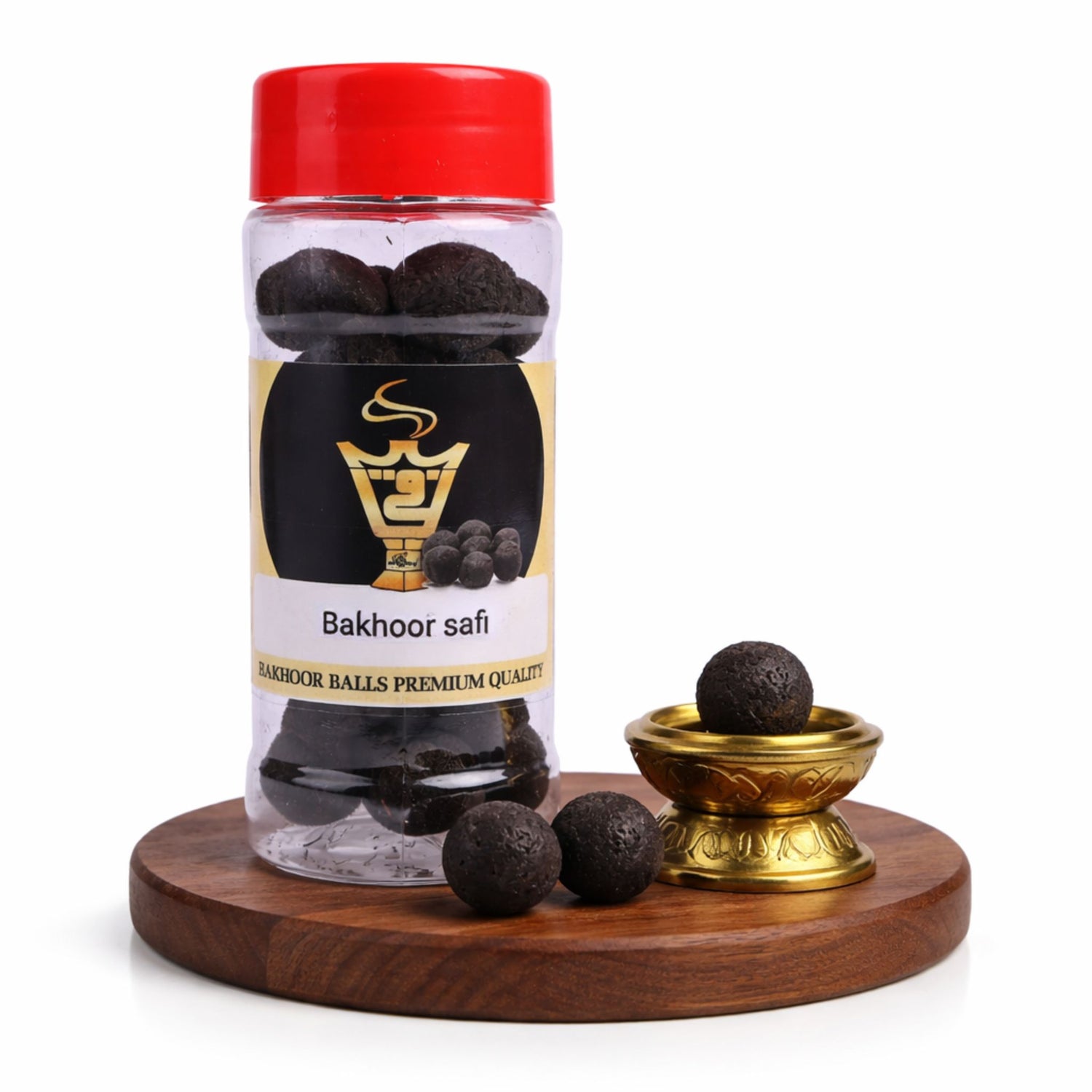 Bottle of Bakhoor safi with a red cap on a wooden stand, surrounded by black resin balls.