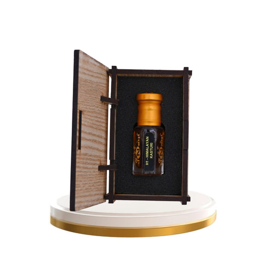 Elegant bottle of Himalayan Kasturi Attar with intricate gold detailing.