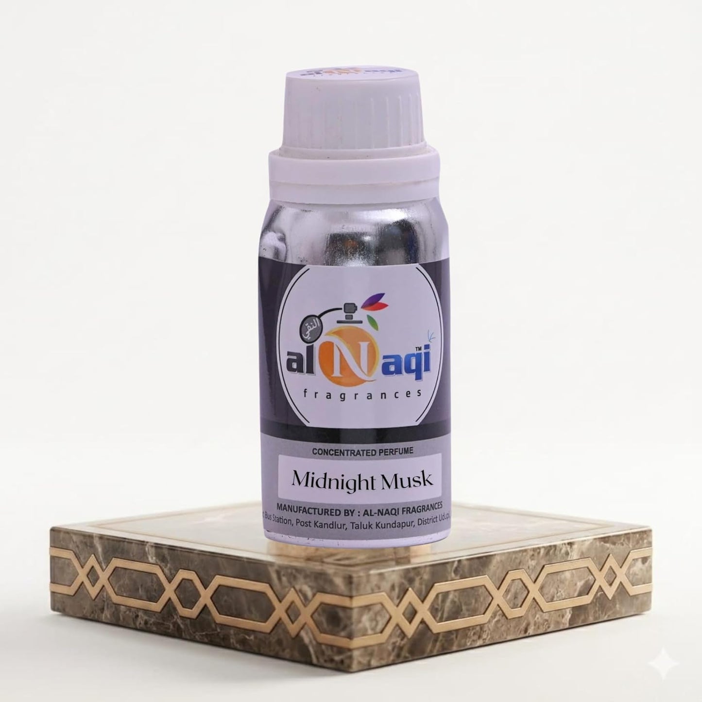 Bottle of Al-Naqi Midnight Musk perfume on a decorative stand with a white background
