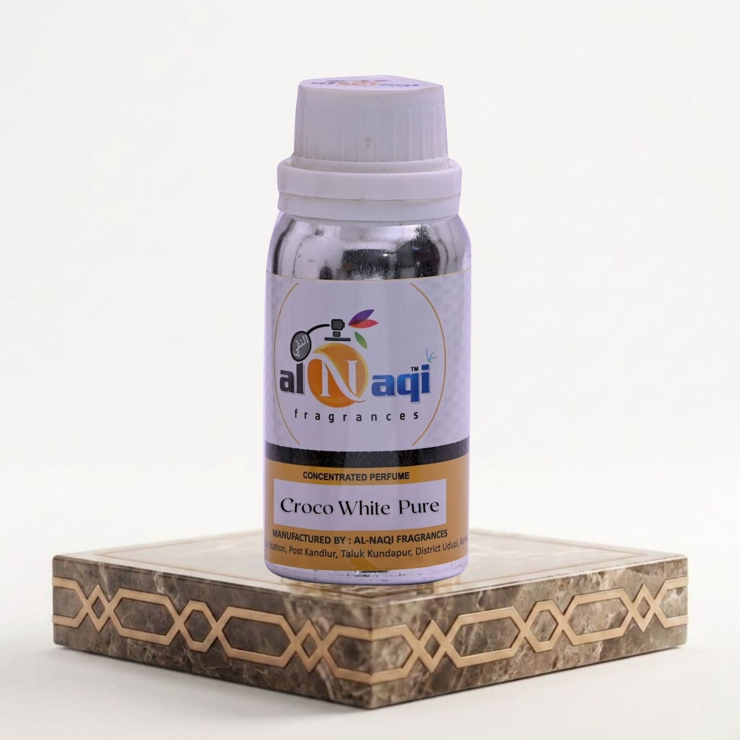 Bottle of Al-Naqi Croco White Pure perfume on a decorative stand with a white background