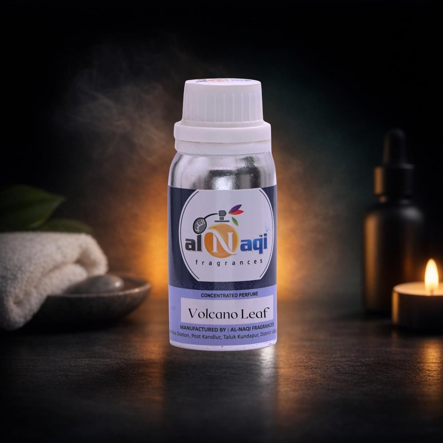 Bottle of Al-Naqi Volcano Leaf fragrance with a candle and towel in the background