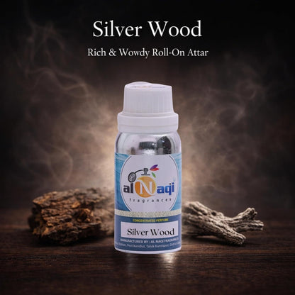 Bottle of Silver Wood roll-on attar with Al-Naqi branding on a dark background