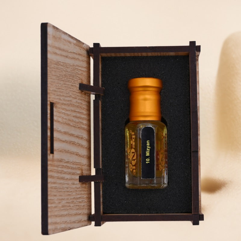 Small bottle with gold cap in a wooden box on a beige background