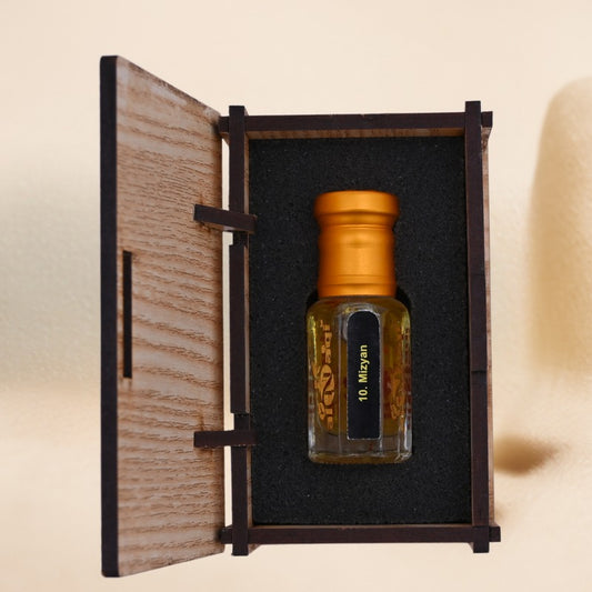 Small bottle with gold cap in a wooden box on a beige background