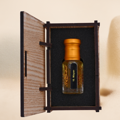 Small bottle with gold cap in a wooden box on a beige background