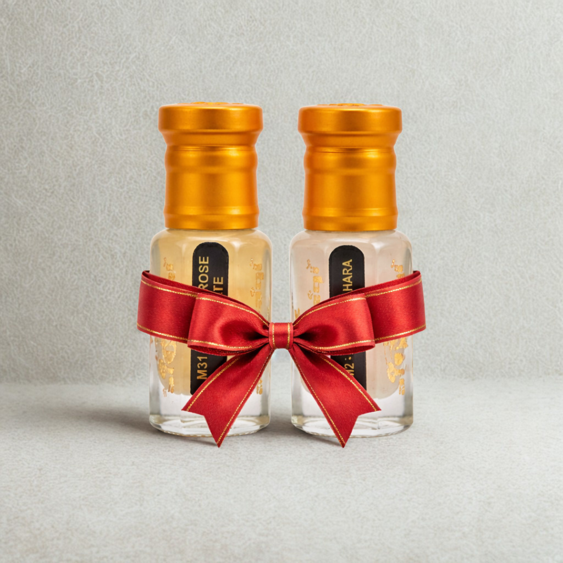 Musk Rose White and Musk Tahara attar oil duo gift set tied with red satin ribbon bow