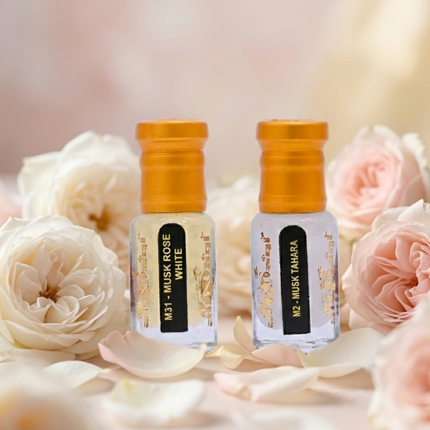 Two small bottles of perfume with gold caps on a background of white and pink roses.