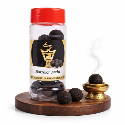 Bakhoor Dania product with a red cap and wooden base on a white background