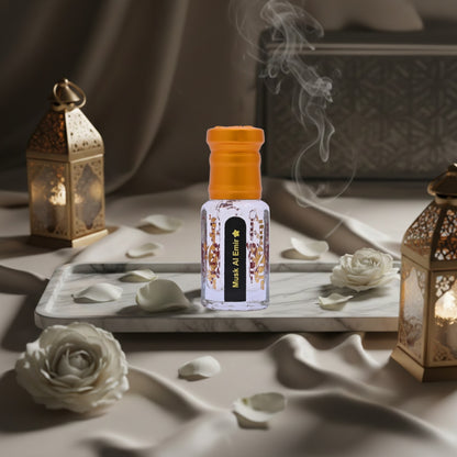 Perfume bottle with orange cap on a marble tray with white roses and lanterns in the background