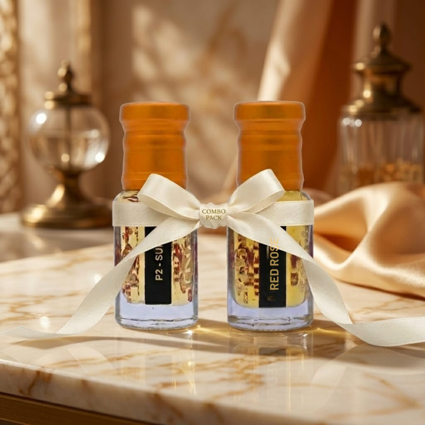 Two small bottles with decorative ribbons on a marble surface
