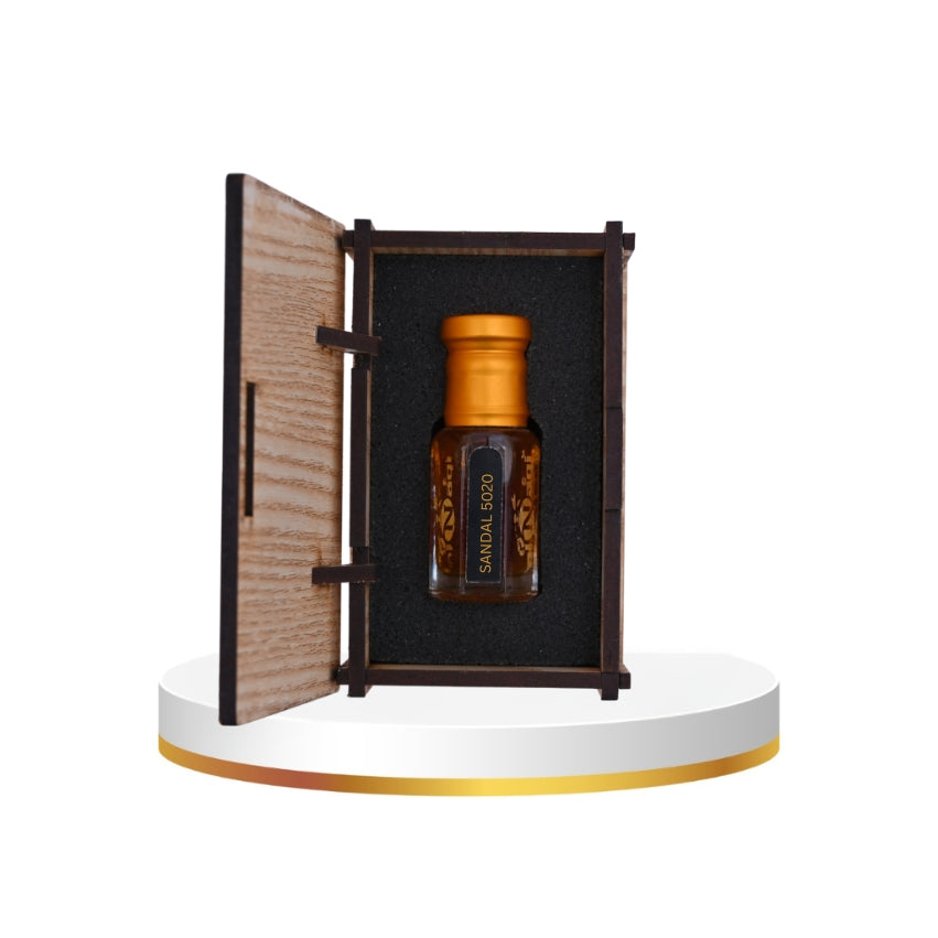 Sandalwood essential oil bottle in a wooden box on a white platform