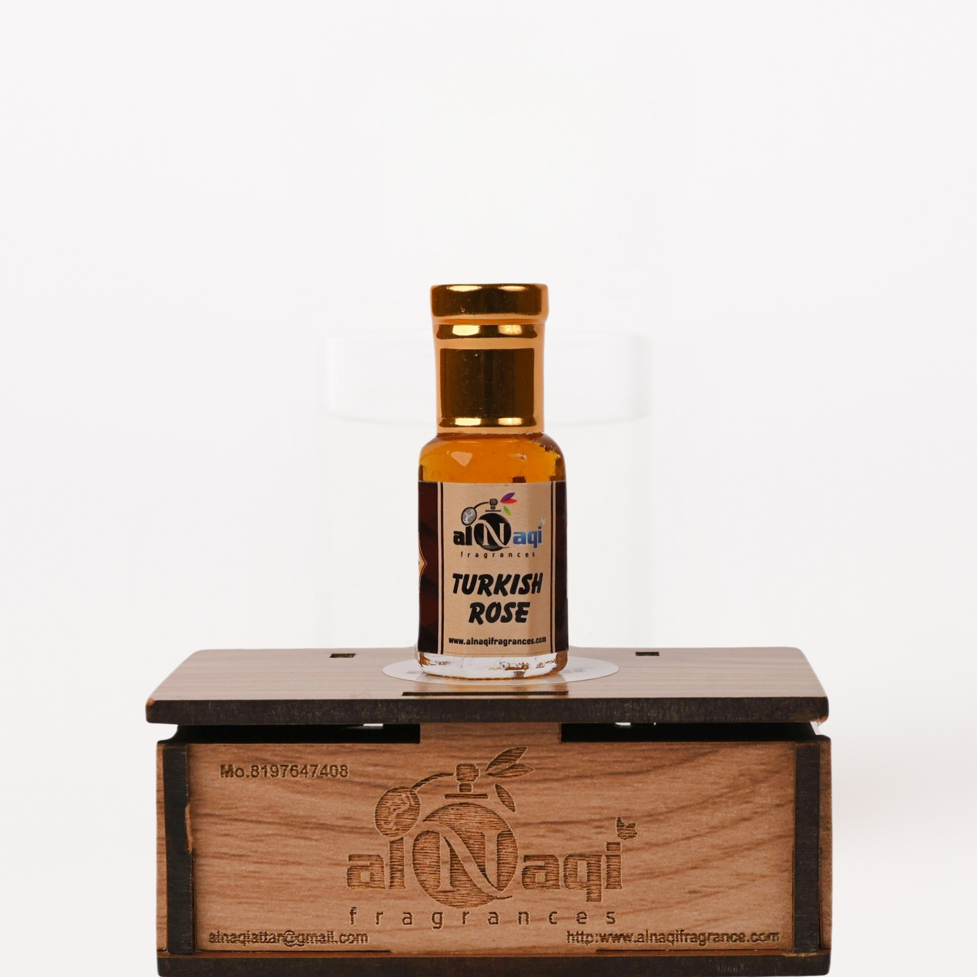 Small bottle of Turkish Rose perfume on a wooden stand with 'al-Naqi' branding.