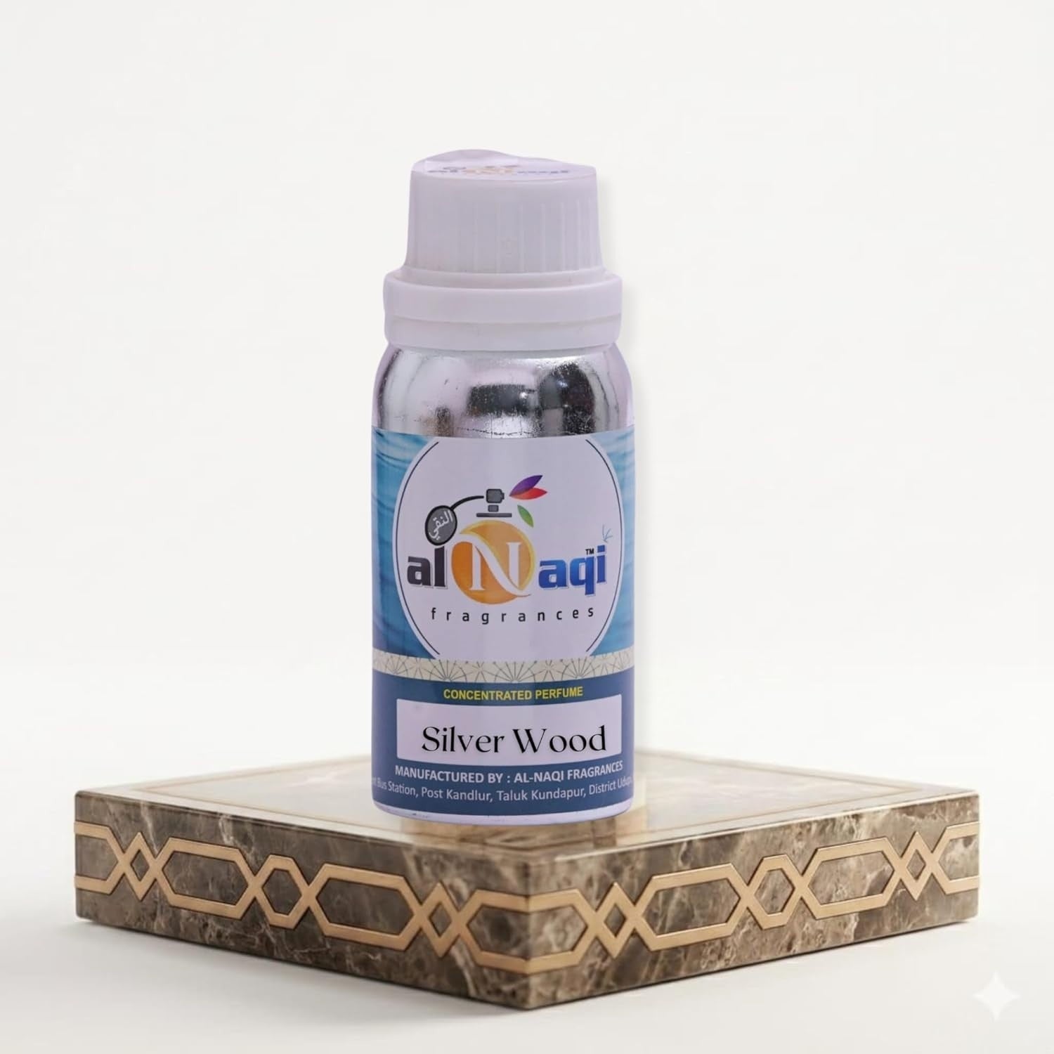 Bottle of Al-Naqi fragrances Silver Wood on a decorative stand with a white background