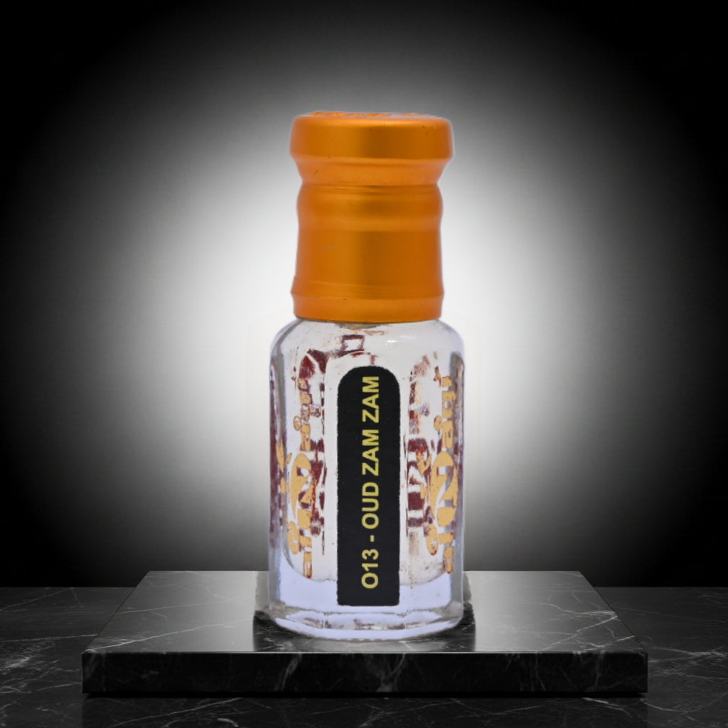 Small glass bottle with an orange cap on a dark marble surface